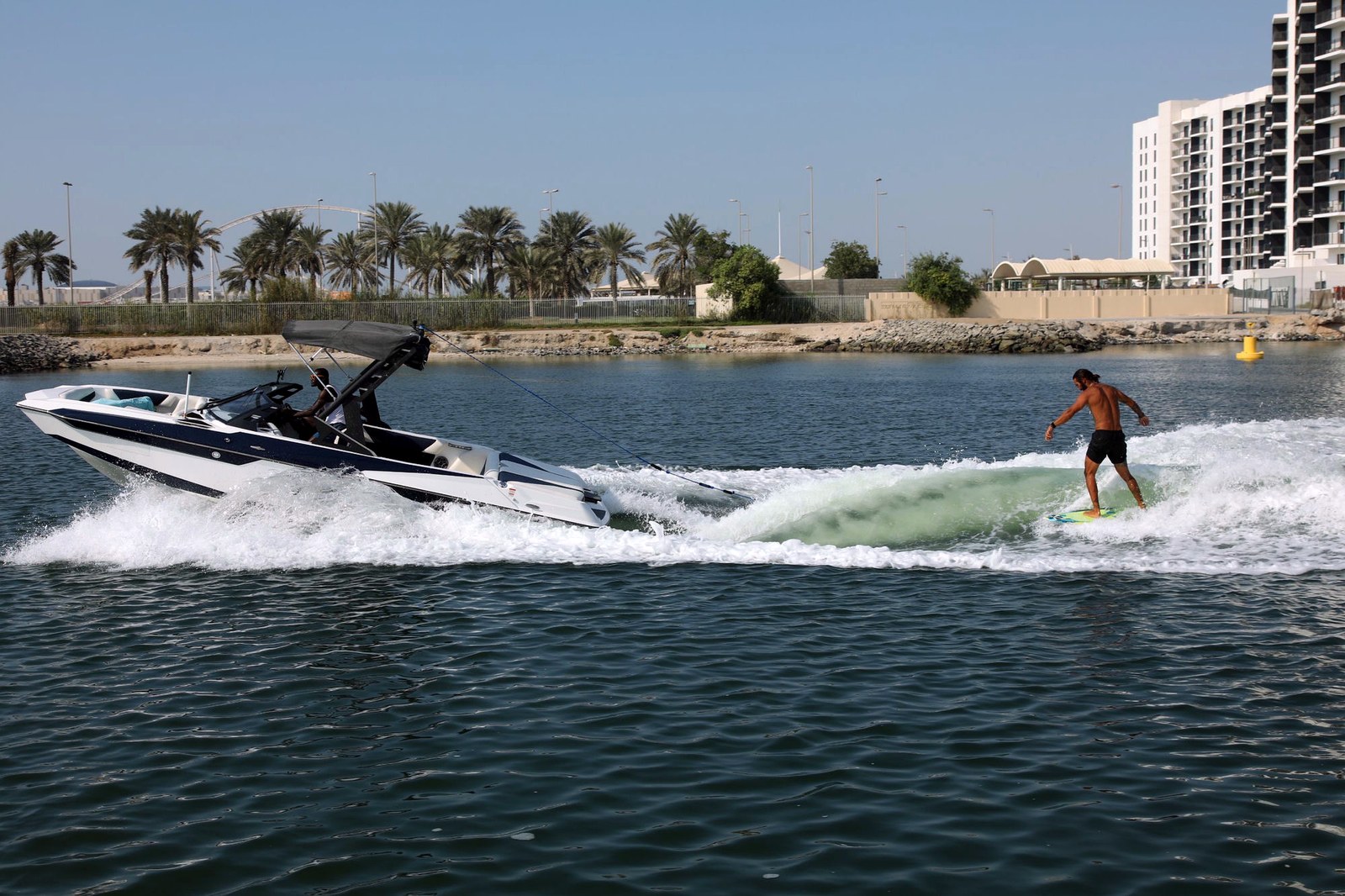 Eywoa Malibu wake boat towing a wakesurfer, aerial view near Yas Marina Abu Dhabi